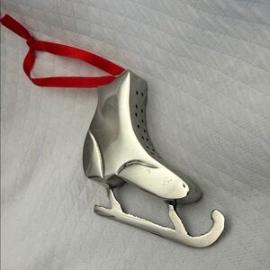 Vintage silver coloured metal Ice Skate Ornament with Red Ribbon